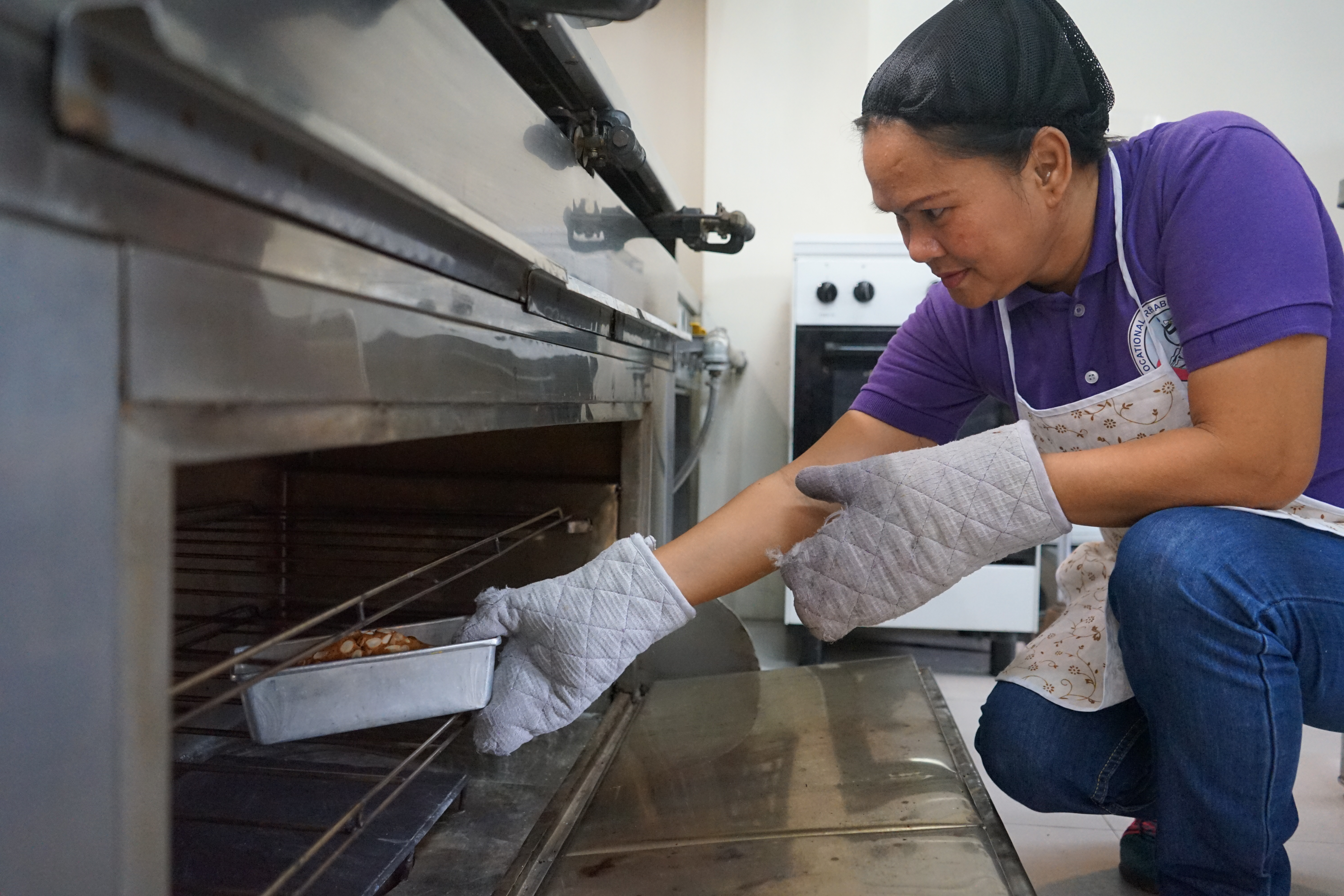 Suzette checks the quality of her baked cakes