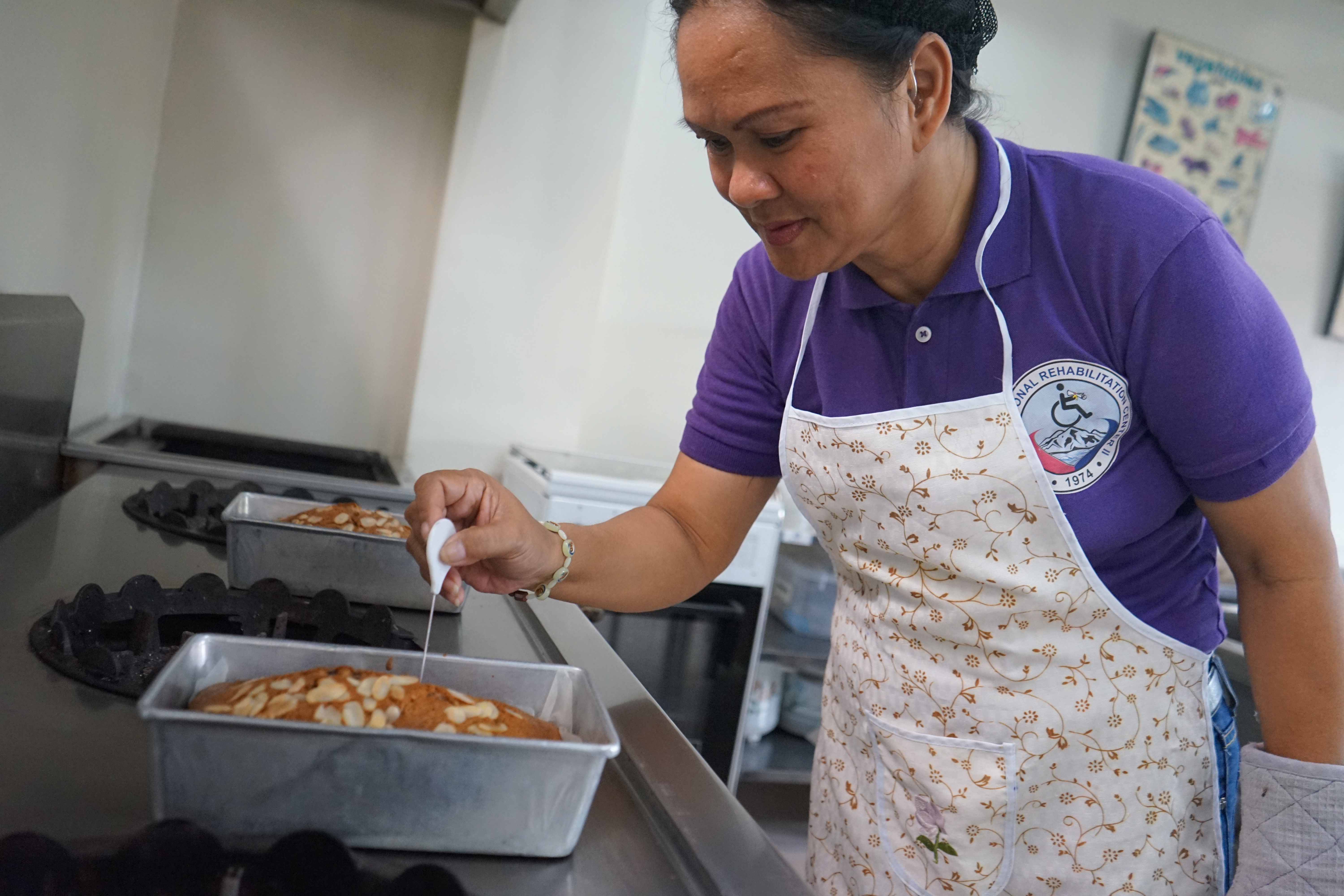 Suzette checks the quality of her baked cakes